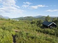 Mountain lodge on the shore of lake Lulealven, Lule river dam in Saltoluokta in birch forest in Sweden Lapland. Summer Royalty Free Stock Photo