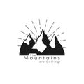 Mountain logo with snow ice tops and retro sun rays in hipster style. Mountain peaks, tourism concept, hiking Royalty Free Stock Photo