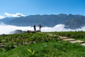 Mountain and low clouds view with stone walking steps and traveller taking landscape photo in Sapa town, Vietnam