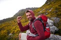 Mountain, man and celebration for hiking in portrait, peak and journey with success and freedom outdoor. Trekking, rock Royalty Free Stock Photo