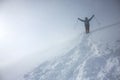 Mountain man descending a snowy slope with a happy salute Royalty Free Stock Photo