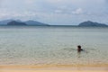 Mountain with man floating over the sea with bright sky in background in the afternoon at Koh Mak Island in Trat, Thailand Royalty Free Stock Photo