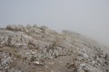 Mountain massif through dense fog, Dolomites, Italian Alps Royalty Free Stock Photo