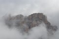 Mountain massif inside dense fog, Dolomites, Italy Royalty Free Stock Photo