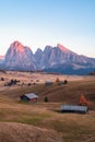 Mountain meadow and house Alpe di Siusi or Seiser Alm in the background Langkofel mountain range at sunset with Province of Royalty Free Stock Photo