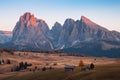 Mountain meadow and house Alpe di Siusi or Seiser Alm in the background Langkofel mountain range at sunset with Province of Royalty Free Stock Photo