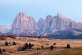 Mountain meadow and house Alpe di Siusi or Seiser Alm in the background Langkofel mountain range at sunset with Province of Royalty Free Stock Photo