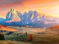 Mountain meadow and wood house Alpe di Siusi or Seiser Alm in the background Langkofel mountain range at beautiful sunset with