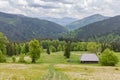 Mountain meadow with wooden herdsman hut in the Carpathian Mountains Royalty Free Stock Photo