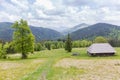 Mountain meadow with wooden herdsman hut in the Carpathian Mountains Royalty Free Stock Photo