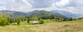 Mountain meadow with wooden herdsman huts in Carpathian Mountains, panorama Royalty Free Stock Photo