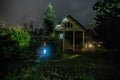 Mountain night landscape of building at forest at night with moon or vintage country house at night with clouds and stars. Summer Royalty Free Stock Photo