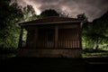 Mountain night landscape of building at forest at night with moon or vintage country house at night with clouds and stars. Summer Royalty Free Stock Photo