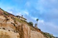 Mountain with ocean front homes against cloudy blue sky in San Diego California Royalty Free Stock Photo