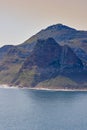 A mountain in the ocean at Hout Bay, South Africa on a summer day. Sea tropical landscape or Mediterranean seascape on a Royalty Free Stock Photo