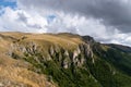 Mountain overgrown in grass with rocky cliffs