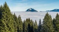 Mountain stick out of foggy cloud layer. Sea of clouds. Gruenten, Allgau, Germany.