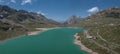 Mountain panorama at the Lago Bianco reservoir at the Bernina Pass from above Royalty Free Stock Photo