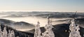 Winter mountain panorama with many mountain ranges, mist and clear sky above from hiking trail bellow Lysa hora hill in Royalty Free Stock Photo