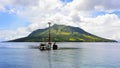 mountain view with misty clouds and offshore platform