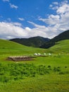 Mountain pasture farm with yurts in Kazakhstan\'s mountains.