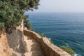 Mountain path over the sea. Stone steps high in the rocks Royalty Free Stock Photo