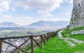 Mountain path with a wooden fence on a blue sky background. The Italian Apennines. Royalty Free Stock Photo