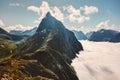 Mountain peak above clouds landscape in Norway aerial view travel destinations Sunnmore Alps