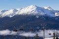 Mountain peak and chair lift with skiers, winter landscape, ski resort, Whistler BC. Royalty Free Stock Photo