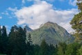 Mountain peak covered with forest against blue sky Royalty Free Stock Photo