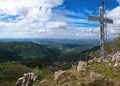 Mountain peak with cross and dramatic light. Royalty Free Stock Photo