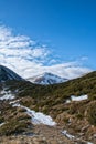 Mountain peak and a path through juniper bushes in late autumn Royalty Free Stock Photo