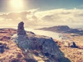 Mountain peak rising on small island in Norway. Stacked pyramid