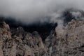 Mountain peak shrouded in thick clouds. The rocky surface is partially visible, creating a dramatic and mysterious atmosphere. Royalty Free Stock Photo