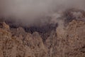 Mountain peak shrouded in thick clouds. The rocky surface is partially visible, creating a dramatic and mysterious atmosphere. Royalty Free Stock Photo