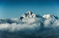 Mountain peak with snow in cloud on blue sky background Royalty Free Stock Photo