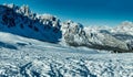 Mountain peak and snowy valley in winter season against a beautiful sunny blue sky Royalty Free Stock Photo