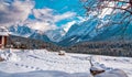 Mountain peak and snowy valley in winter season against a beautiful sunny blue sky Royalty Free Stock Photo