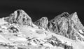 Mountain peak and snowy valley in winter season against a beautiful sunny blue sky Royalty Free Stock Photo