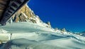 Mountain peak and snowy valley in winter season against a beautiful sunny blue sky Royalty Free Stock Photo
