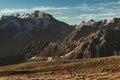 Mountain peak sunset landscape with gloomy dramatic mainly cloudy sky and orange and red sun beams Royalty Free Stock Photo