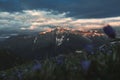 Mountain peak sunset landscape with gloomy dramatic mainly cloudy sky and orange and red sun beams Royalty Free Stock Photo