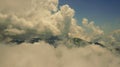 A mountain summit piercing through clouds