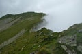 A mountain peak veiling from one side into the mist