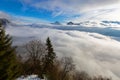 Mountain peaks of Alps above layers of clouds drifting in Austria, Europe. Royalty Free Stock Photo