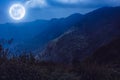 Mountain peaks with blue sky and beautiful full moon. Royalty Free Stock Photo