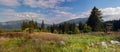 Mountain peaks in bright sunlight. Wooden constructions for training on a meadow