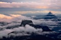 Mountain peaks in the clouds. Sunrise on Adam`s Peak. Shadow from Mount Adam peak Royalty Free Stock Photo