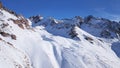 Mountain peaks covered with snow. Blue sky with light white clouds. Royalty Free Stock Photo