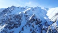 Mountain peaks covered with snow. Blue sky with light white clouds. Royalty Free Stock Photo